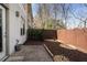 Cozy backyard with a stone patio, mulched garden beds, and a wooden fence for privacy at 1342 Rietveld Nw Row, Atlanta, GA 30318