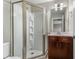 Bathroom features a glass shower stall, dark cabinets, and recessed lighting at 1342 Rietveld Nw Row, Atlanta, GA 30318