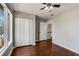 Bedroom featuring hardwood floors, closet, and natural light from large windows at 1342 Rietveld Nw Row, Atlanta, GA 30318