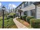 Classic home with a welcoming front porch, surrounded by lush landscaping and a well-maintained walkway at 245 Hollyberry Ct, Roswell, GA 30076