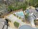 Aerial view of a home with a private swimming pool surrounded by greenery at 3405 Camellia Ln, Suwanee, GA 30024