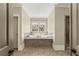 Luxurious bathroom featuring a soaking tub, a separate shower, and elegant tile work for a spa-like experience at 3405 Camellia Ln, Suwanee, GA 30024