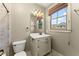 Bathroom featuring a vanity with drawers, toilet, and window with blind at 3405 Camellia Ln, Suwanee, GA 30024