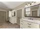 Elegant bathroom features double vanities with granite counters and bronze fixtures at 3405 Camellia Ln, Suwanee, GA 30024