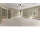 Bedroom with plush carpeting, neutral paint, multiple windows, and a ceiling fan for added comfort at 3405 Camellia Ln, Suwanee, GA 30024