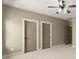 Bedroom featuring neutral paint, white trim, and two doors at 3405 Camellia Ln, Suwanee, GA 30024