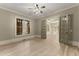 A bright bedroom with hardwood floors, a ceiling fan, and French doors at 3405 Camellia Ln, Suwanee, GA 30024