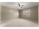 Spacious bedroom with soft carpet, neutral walls, and two windows for lots of light at 3405 Camellia Ln, Suwanee, GA 30024