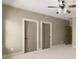 Large bedroom with neutral walls, plush carpet, and two closets at 3405 Camellia Ln, Suwanee, GA 30024