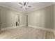 Spacious bedroom with hardwood floors and a view of ensuite bathroom at 3405 Camellia Ln, Suwanee, GA 30024