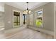 Bright dining room with lots of natural light from the windows with a light fixture at 3405 Camellia Ln, Suwanee, GA 30024