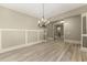 Elegant dining room features modern chandelier and light hardwood floors at 3405 Camellia Ln, Suwanee, GA 30024