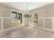 Bright dining room boasts hardwood floors and large windows offering outdoor views at 3405 Camellia Ln, Suwanee, GA 30024