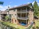 The exterior of the home features dual covered balconies and a fenced yard at 3405 Camellia Ln, Suwanee, GA 30024