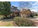 Two-story brick home with stone accents, a two-car garage, and mature landscaping at 3405 Camellia Ln, Suwanee, GA 30024