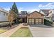Charming brick home with a well-manicured lawn, stone accents, and a brick walkway at 3405 Camellia Ln, Suwanee, GA 30024