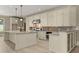 Well-equipped kitchen with custom cabinets, stone backsplash, and spacious center island at 3405 Camellia Ln, Suwanee, GA 30024