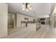 Open kitchen and living space with custom cabinets, granite countertops, an island, and a fireplace at 3405 Camellia Ln, Suwanee, GA 30024