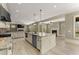 Open kitchen featuring an island, modern appliances, and an adjacent living room with a fireplace at 3405 Camellia Ln, Suwanee, GA 30024