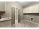 Laundry room with tile flooring, lots of cabinet space, and a sink at 3405 Camellia Ln, Suwanee, GA 30024