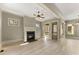Living room with a black fireplace, bright windows, and hardwood flooring at 3405 Camellia Ln, Suwanee, GA 30024