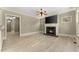 Bright living room with hardwood floors, a fireplace, and a large flat-screen TV at 3405 Camellia Ln, Suwanee, GA 30024