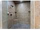 Tiled shower with a rainfall showerhead, corner shelves, and a built-in seat for a luxurious bathing experience at 3405 Camellia Ln, Suwanee, GA 30024