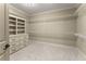 Spacious walk-in closet with custom shelving and drawers, providing ample storage for an organized wardrobe at 3405 Camellia Ln, Suwanee, GA 30024