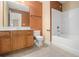 Bathroom with double sink vanity, tub, and neutral tile floors at 907 Hindman Pl, Mcdonough, GA 30253