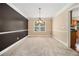 Neutral dining room featuring wainscoting, a window, and carpet flooring at 907 Hindman Pl, Mcdonough, GA 30253