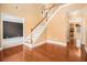 Bright entryway showcasing hardwood floors and a staircase with white railings and wooden banister at 907 Hindman Pl, Mcdonough, GA 30253