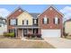 Traditional two-story home with brick and siding, black shutters, and an attached two-car garage at 907 Hindman Pl, Mcdonough, GA 30253