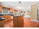 Bright kitchen boasts wood cabinets, granite countertops, tiled backsplash, and an island with hardwood floors throughout at 907 Hindman Pl, Mcdonough, GA 30253