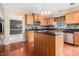 Well-equipped kitchen featuring wood cabinets, stainless steel appliances, and center island at 907 Hindman Pl, Mcdonough, GA 30253