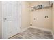 Neutral laundry room features gray vinyl floors, paint storage, and a utility sink hookup at 907 Hindman Pl, Mcdonough, GA 30253