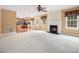 Inviting living room with a fireplace, plush carpet, and an open view of the kitchen at 907 Hindman Pl, Mcdonough, GA 30253