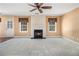 Spacious living room with plush carpeting, a fireplace, and bright natural light at 907 Hindman Pl, Mcdonough, GA 30253