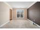 Cozy living room with neutral carpet, large window, and two-tone wall at 907 Hindman Pl, Mcdonough, GA 30253