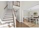 Bright foyer featuring hardwood floors, a staircase, and access to the dining room at 922 Grandview Nw Way, Acworth, GA 30101