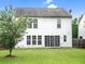 View of a white two-story home in a large backyard with a privacy fence at 3246 Wellington Sw Walk, Atlanta, GA 30331