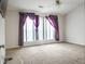 Bedroom features large window with decorative drapes and carpet flooring at 3246 Wellington Sw Walk, Atlanta, GA 30331