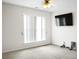 Bright bedroom featuring a window and a wall-mounted TV at 3246 Wellington Sw Walk, Atlanta, GA 30331