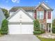 Charming two-story home with a stone accent and a well-manicured front yard with mature trees at 3246 Wellington Sw Walk, Atlanta, GA 30331