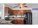 Well-lit kitchen with stainless steel appliances and dark brown cabinets at 3246 Wellington Sw Walk, Atlanta, GA 30331