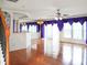 Spacious living room featuring hardwood floors, large windows with elegant drapes, and recessed lighting at 3246 Wellington Sw Walk, Atlanta, GA 30331