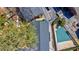 A top down aerial view of real estate featuring townhomes, covered pool, and trees at 4282 Roswell Ne Rd # G1, Atlanta, GA 30342