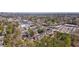 An aerial view of real estate showcasing a townhome community surrounded by trees and stores at 4282 Roswell Ne Rd # G1, Atlanta, GA 30342