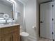 Well-lit bathroom with floating wooden vanity, large mirror, and modern fixtures for a stylish and functional space at 4282 Roswell Ne Rd # G1, Atlanta, GA 30342