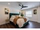 Cozy bedroom featuring a modern bed with a green tufted headboard, stylish lighting, and sleek dark floors at 4282 Roswell Ne Rd # G1, Atlanta, GA 30342