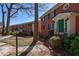 Charming two-story brick building with green door and black shutters at 4282 Roswell Ne Rd # G1, Atlanta, GA 30342